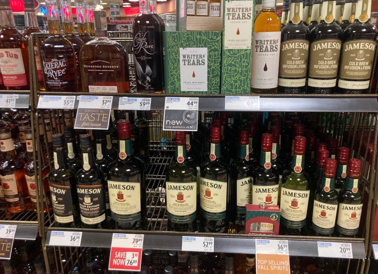 A shelf with bottles of alcohol