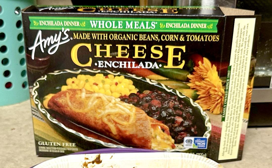 Box of Amy’s Cheese Enchilada Whole Meal featuring an image of an enchilada with melted cheese, black beans, and corn. Packaging highlights gluten-free and organic ingredients.