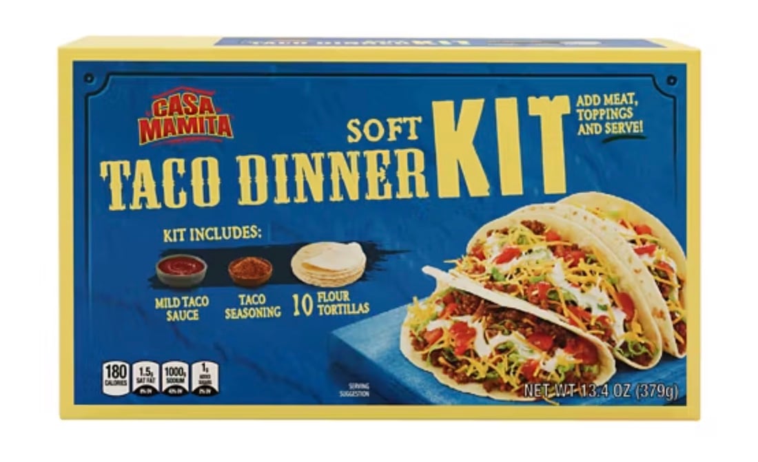 A blue and yellow box of Casa Mamita Soft Taco Dinner Kit, showing two assembled tacos and listing contents: mild taco sauce, taco seasoning, and 10 flour tortillas. Net weight: 13.4 oz (379g). Just one of two taco kits recalled due to a seasoning mixup.