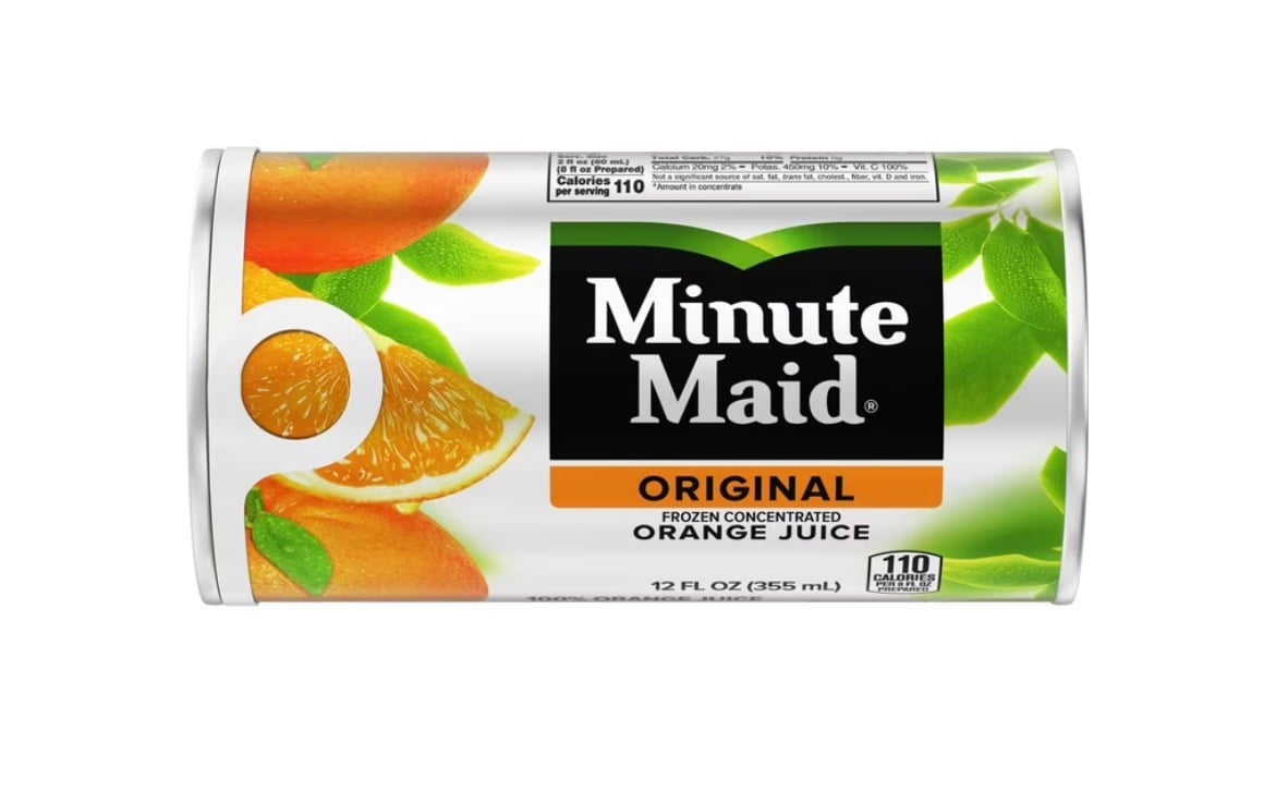 A 12 fl oz can of Minute Maid Original Frozen Concentrated Orange Juice, featuring images of orange slices and green leaves on the label, with nutrition information showing 110 calories per serving.