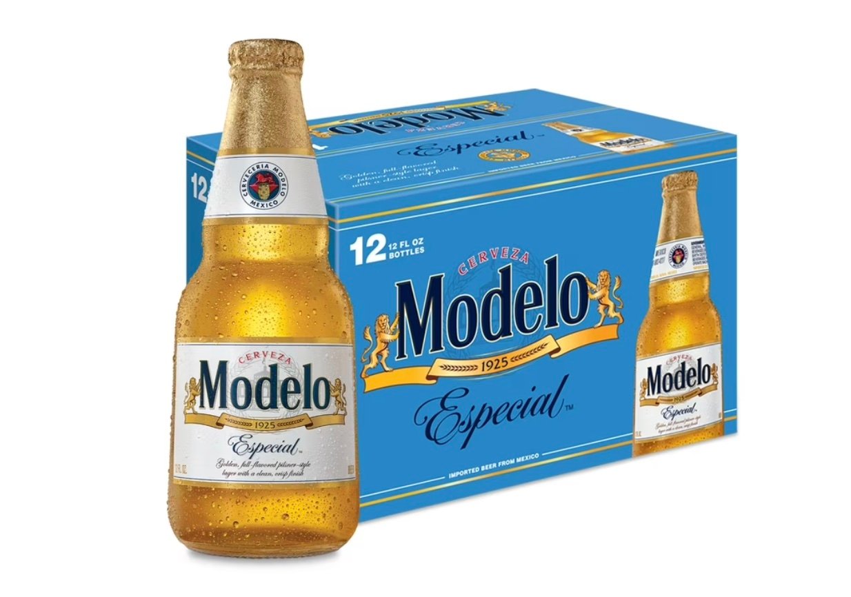A single Modelo Especial beer bottle is shown in front of a blue 12-pack box, both featuring the gold and blue Modelo branding with "Especial" written below the beer's name.