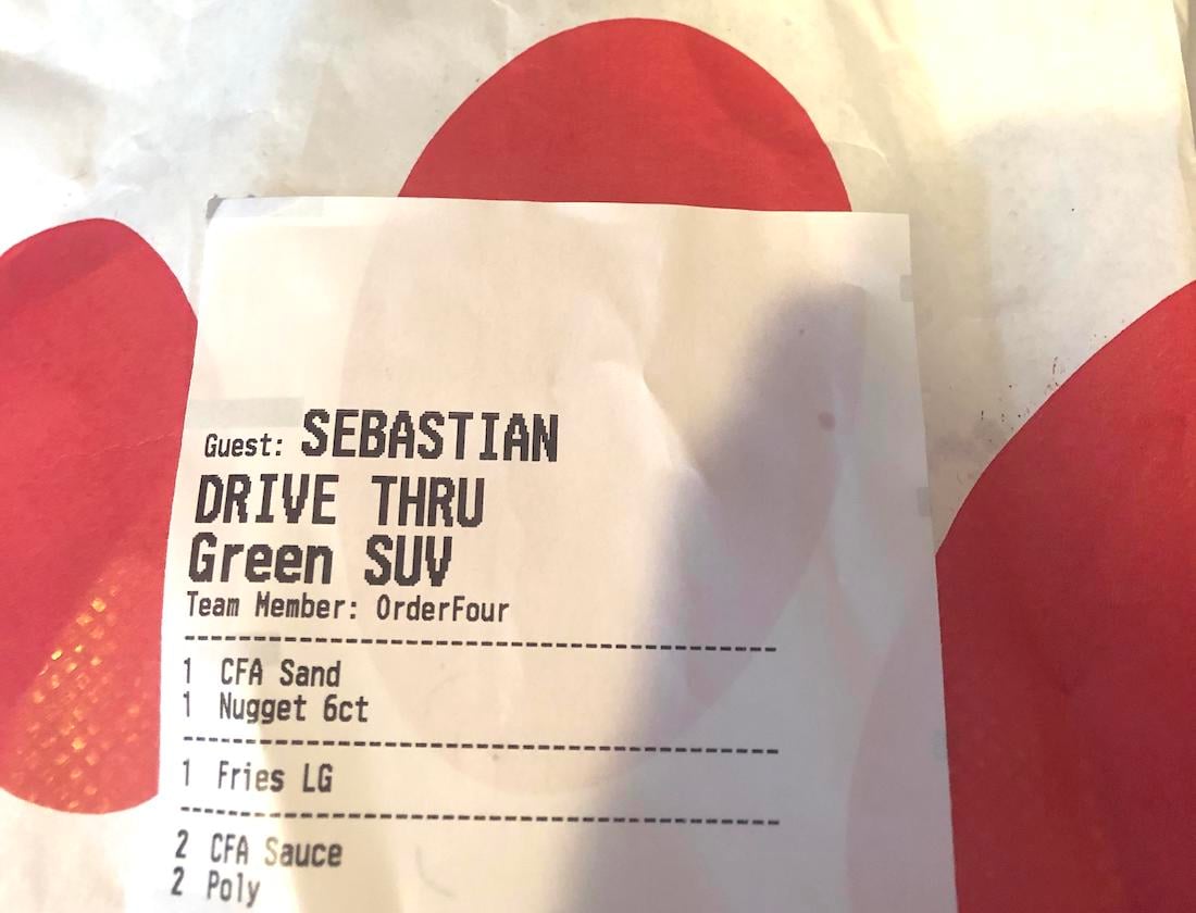 A Chick-fil-A receipt labeled for guest Sebastian with drive-thru pickup in a green SUV, listing items: sandwich, 6-count nuggets, large fries, two CFA sauces, and two Polynesian sauces, on a Chick-fil-A bag.