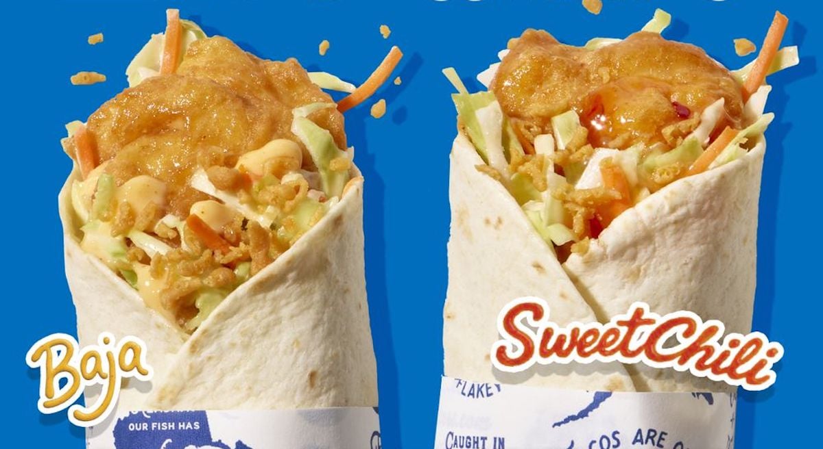 Two fish burritos in white wraps stand upright against a blue background. The left one is labeled "Baja" and the right "Sweet Chili." Both contain fried fish, shredded vegetables, and sauces.