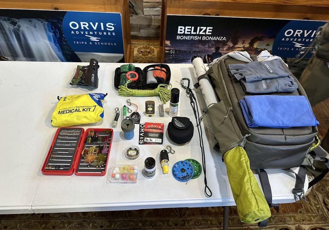 A table with a bag and fishing tackle