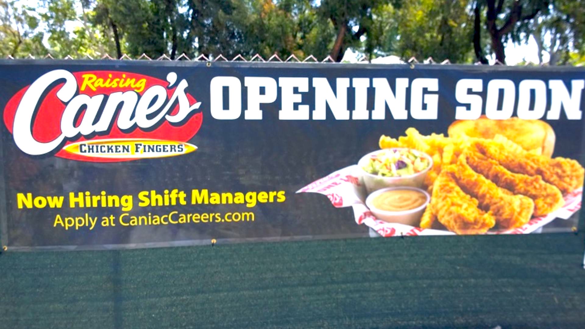 Banner for Raising Cane’s Chicken Fingers announcing "Opening Soon." It also states, "Now Hiring Shift Managers," and shows chicken fingers, fries, coleslaw, and toast. Website: CaniacCareers.com.