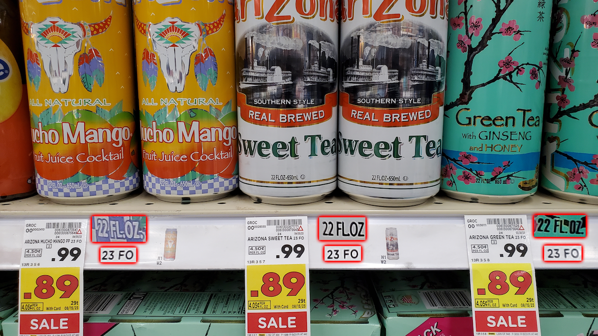 Cans of Arizona drinks, including Mucho Mango, Sweet Tea, and Green Tea, are displayed on a store shelf with sale tags showing prices of $0.89 and $0.99 for 22 fl oz cans.