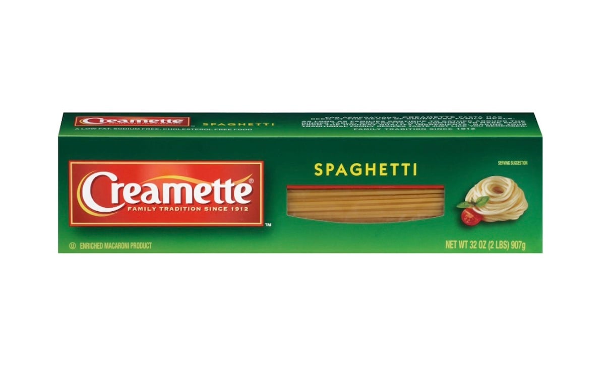 A green box of Creamette Spaghetti, featuring the brand logo, a window showing the uncooked pasta, and an image of cooked spaghetti with tomato sauce and basil. Net weight is 32 oz (907g).