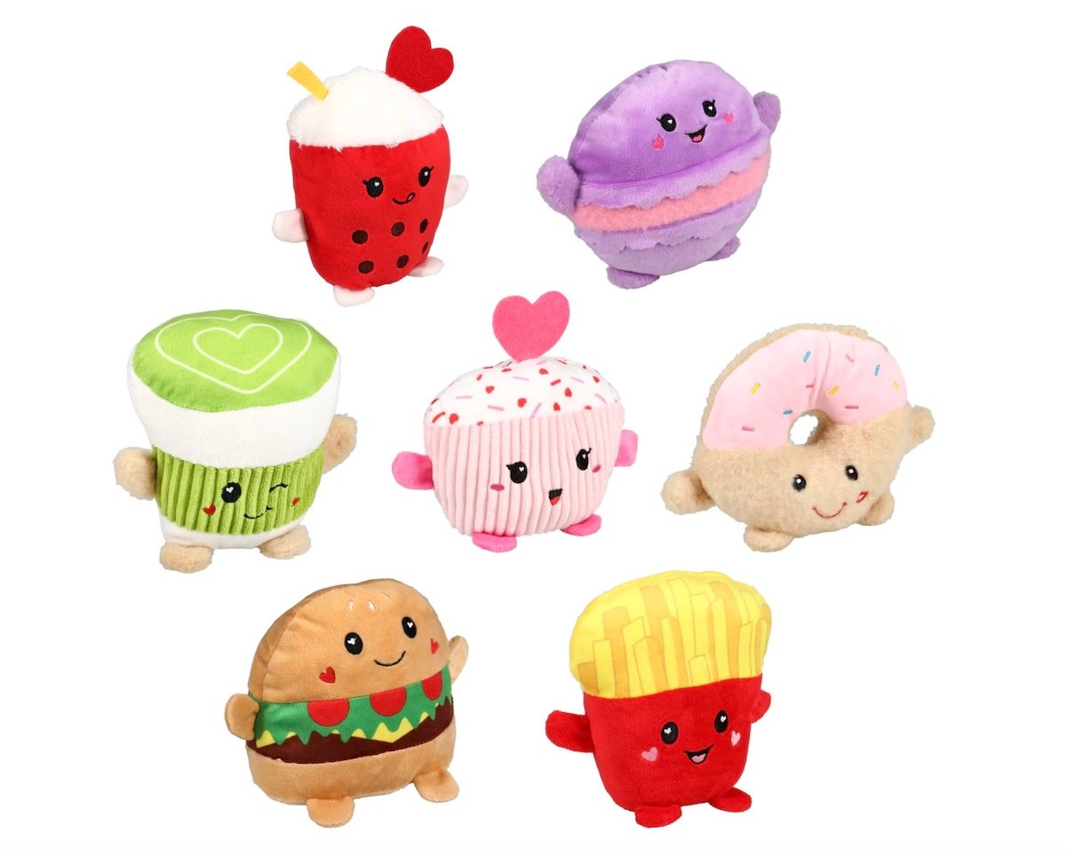 Seven plush toys shaped like cute foods, including boba tea, macaron, cupcake, donut, burger, fries, and a green dessert, each with smiling faces and small arms, arranged on a white background.