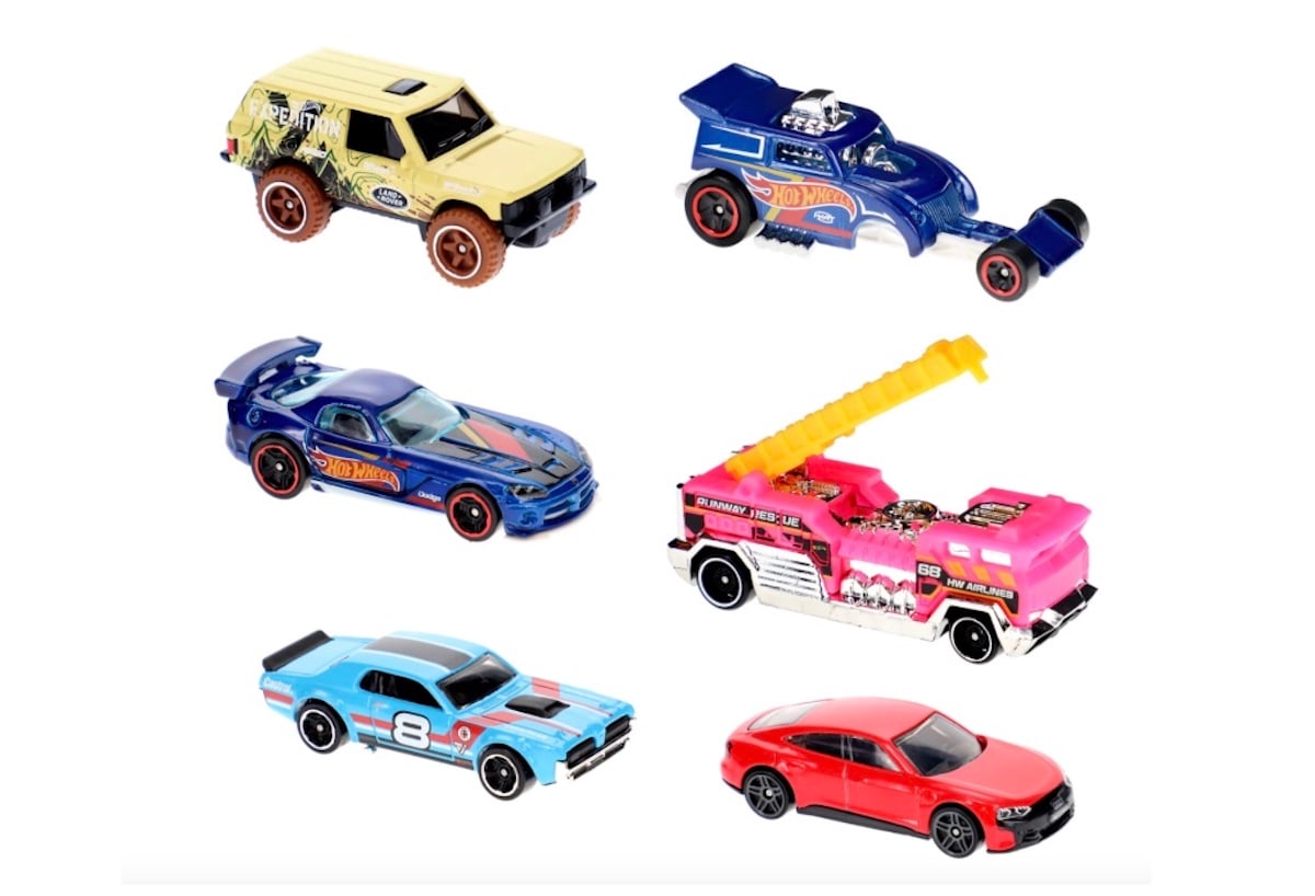 Six toy cars are displayed on a white background, including an SUV, a dragster, a blue sports car, a pink fire truck, a light blue race car, and a red sedan.