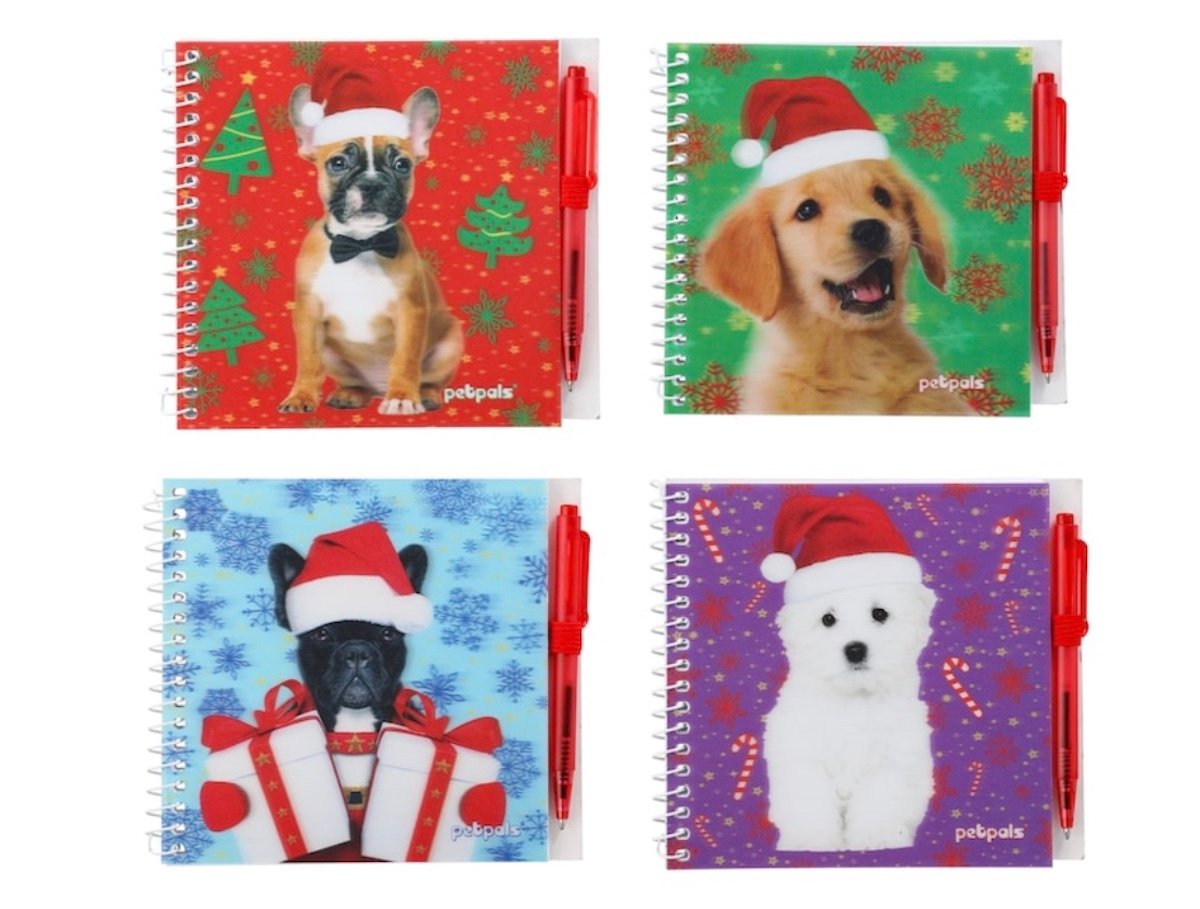 Four square spiral notebooks, each with a pen, featuring different dogs wearing Santa hats on festive holiday backgrounds in red, green, blue, and purple with Christmas-themed designs.