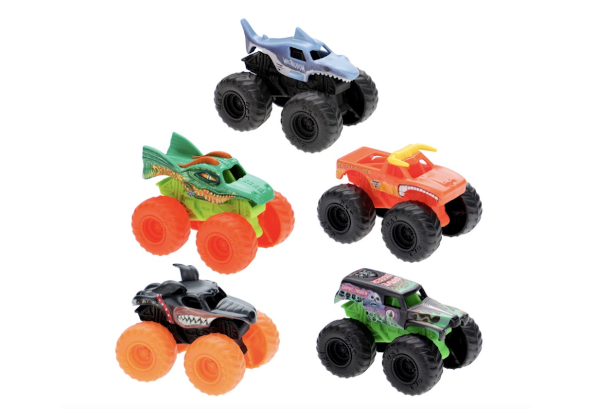 Five colorful toy monster trucks are arranged on a white background. Each truck has oversized wheels and unique designs, including animal and flame motifs in blue, green, orange, black, and green-purple colors.