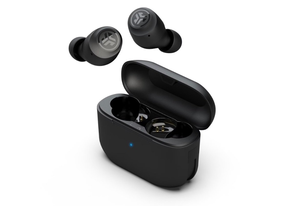 Two black wireless earbuds are shown above an open black charging case with a blue LED indicator on the front. The earbuds and case feature a circular logo on their surfaces.