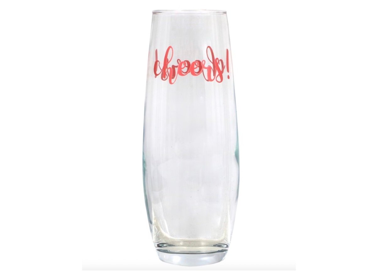 A clear champagne flute with the word "Cheers!" written in red cursive text near the rim, set against a white background.