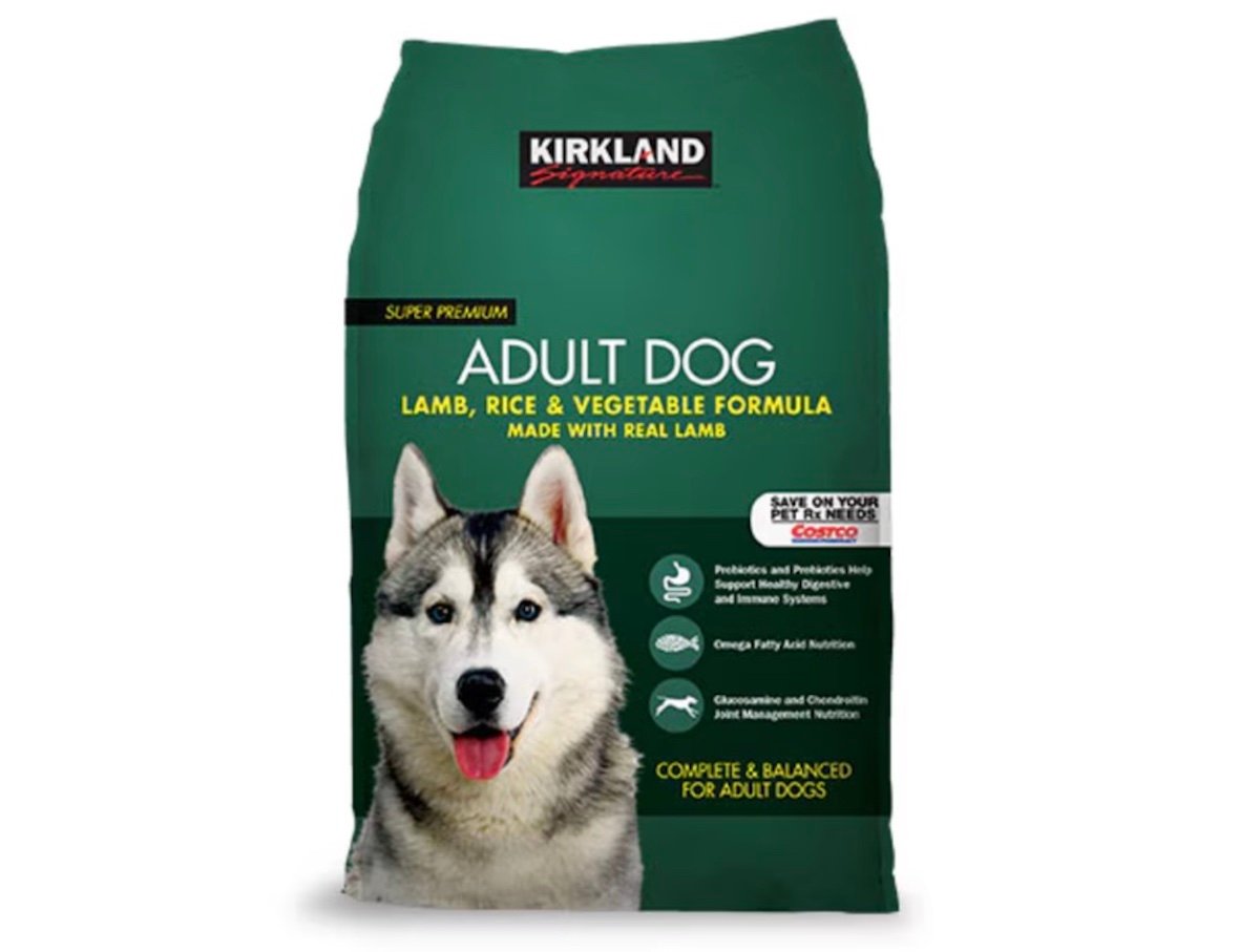 A green bag of Kirkland Signature Adult Dog food featuring a photo of a husky. The label highlights lamb, rice, and vegetable formula, and mentions benefits like real lamb, omega fatty acids, and joint support for adult dogs.