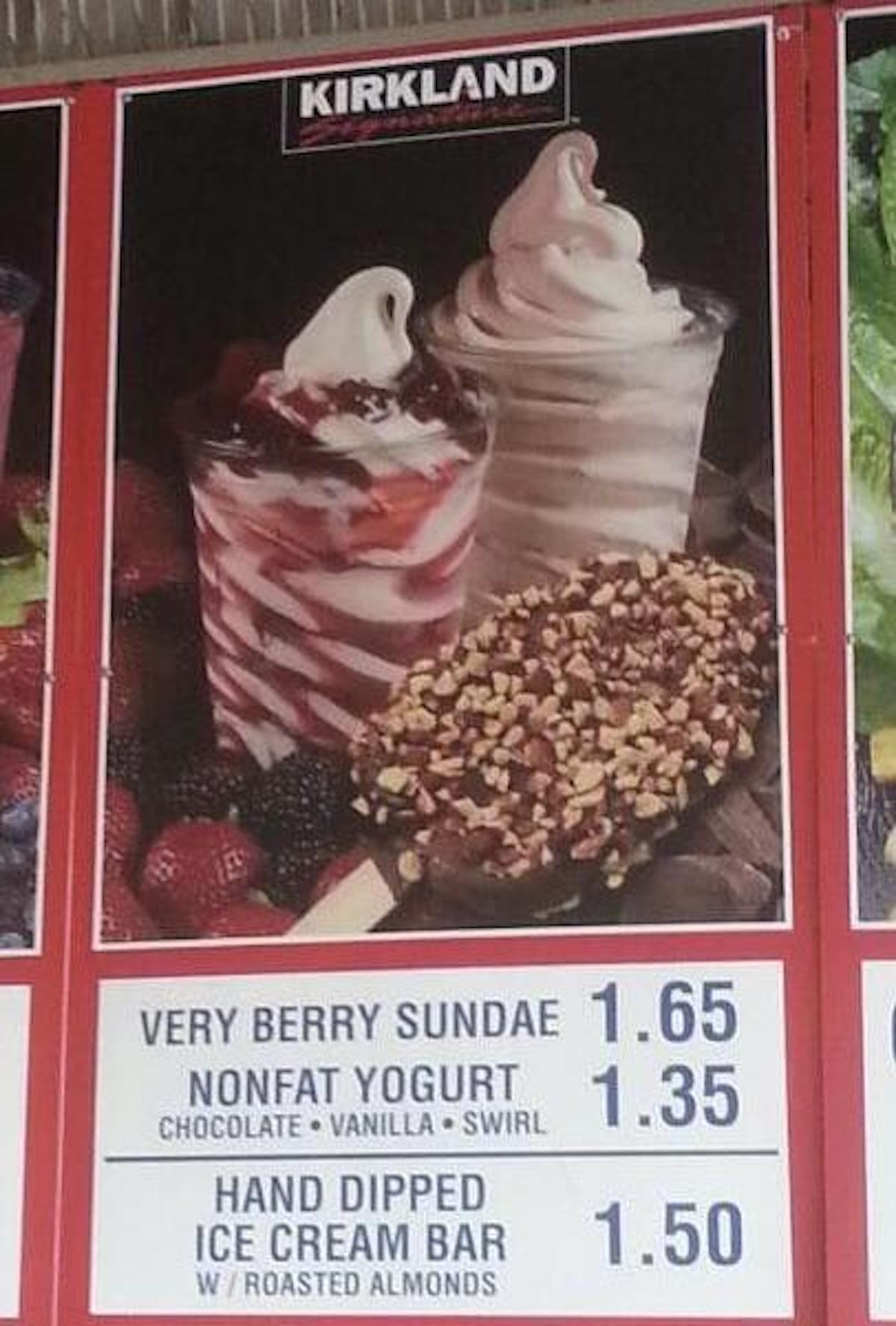 A menu board shows images of a berry sundae, a swirled yogurt cup, and a chocolate-covered ice cream bar with nuts. Prices and options are listed below each item. The Kirkland brand logo is visible at the top.