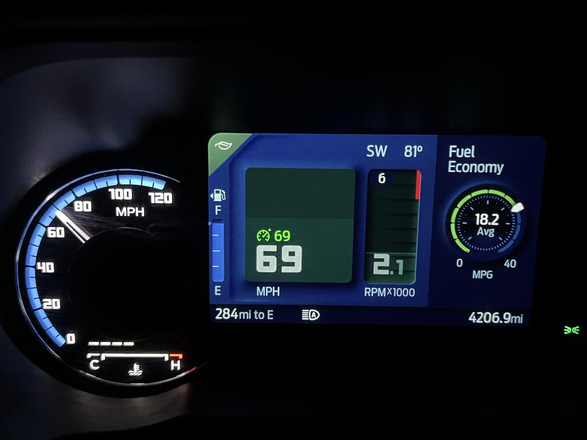 Car dashboard display showing a speed of 69 MPH, 2.1 RPM x1000, 284 miles to empty, 18.2 average MPG, and a total mileage of 4206.9. The outside temperature is 81°F.