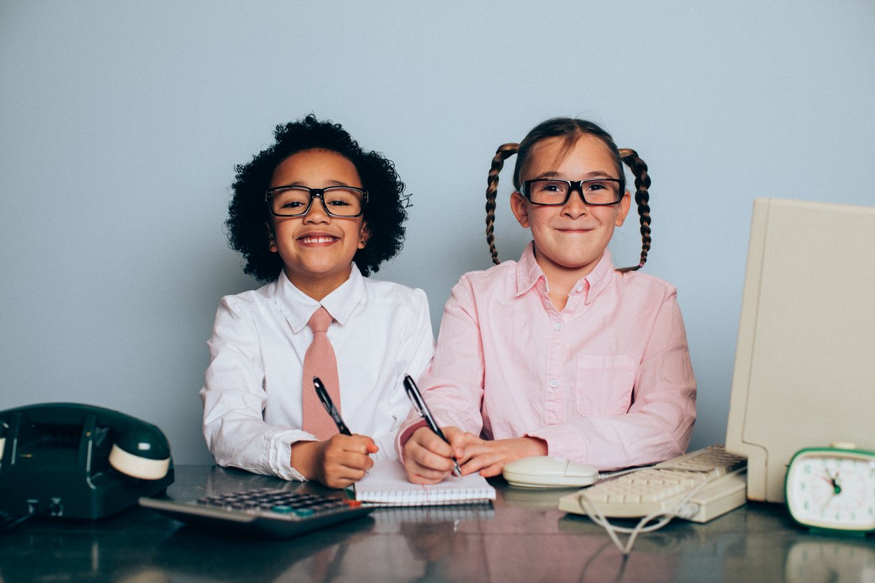 Two young girls working in an office and information technology are happy at wor . They are ready to serve customers while looking at the camera.