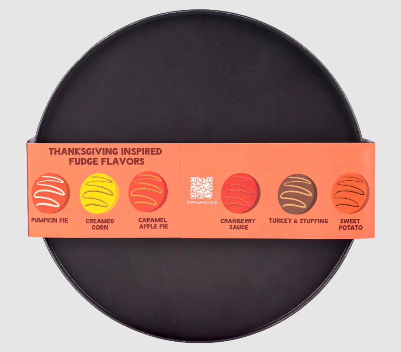 A round black plate with a label listing Thanksgiving-inspired fudge flavors: pumpkin pie, creamed corn, caramel apple pie, cranberry sauce, turkey & stuffing, and sweet potato, each with a corresponding colored swirl icon.