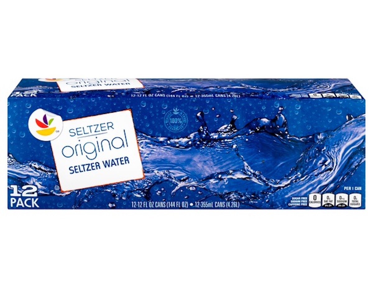 A 12-pack of Seltzer Original Seltzer Water cans in a blue box with water splash graphics and white label. The box displays serving size, calorie, sugar, sodium, and caffeine information.