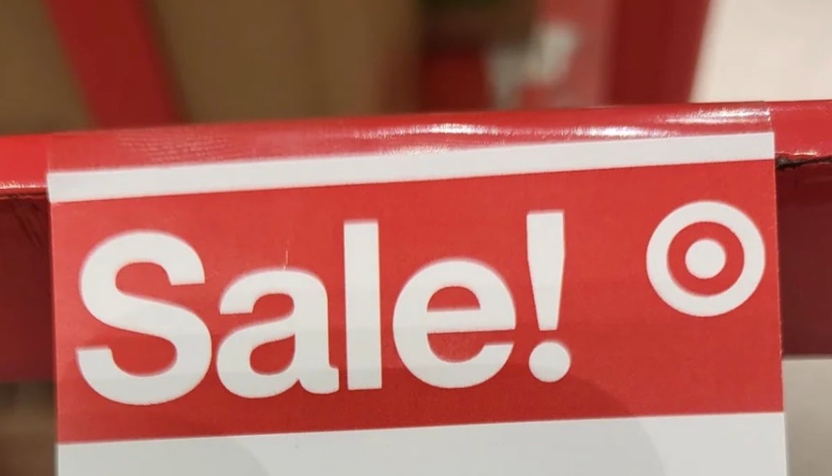A red and white sign with the word "Sale!" in bold letters and the Target store logo on the right side.