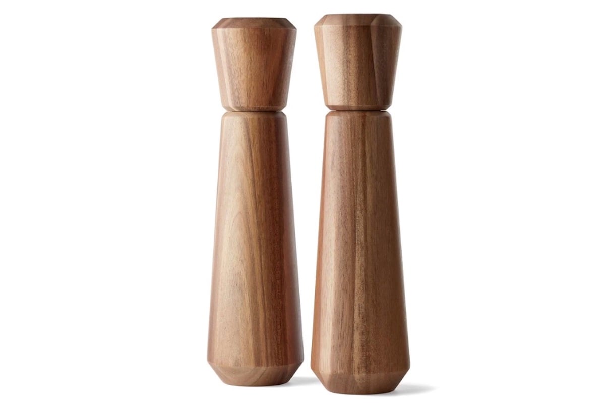 Two wooden salt and pepper mills with a smooth, modern design stand side by side against a white background.