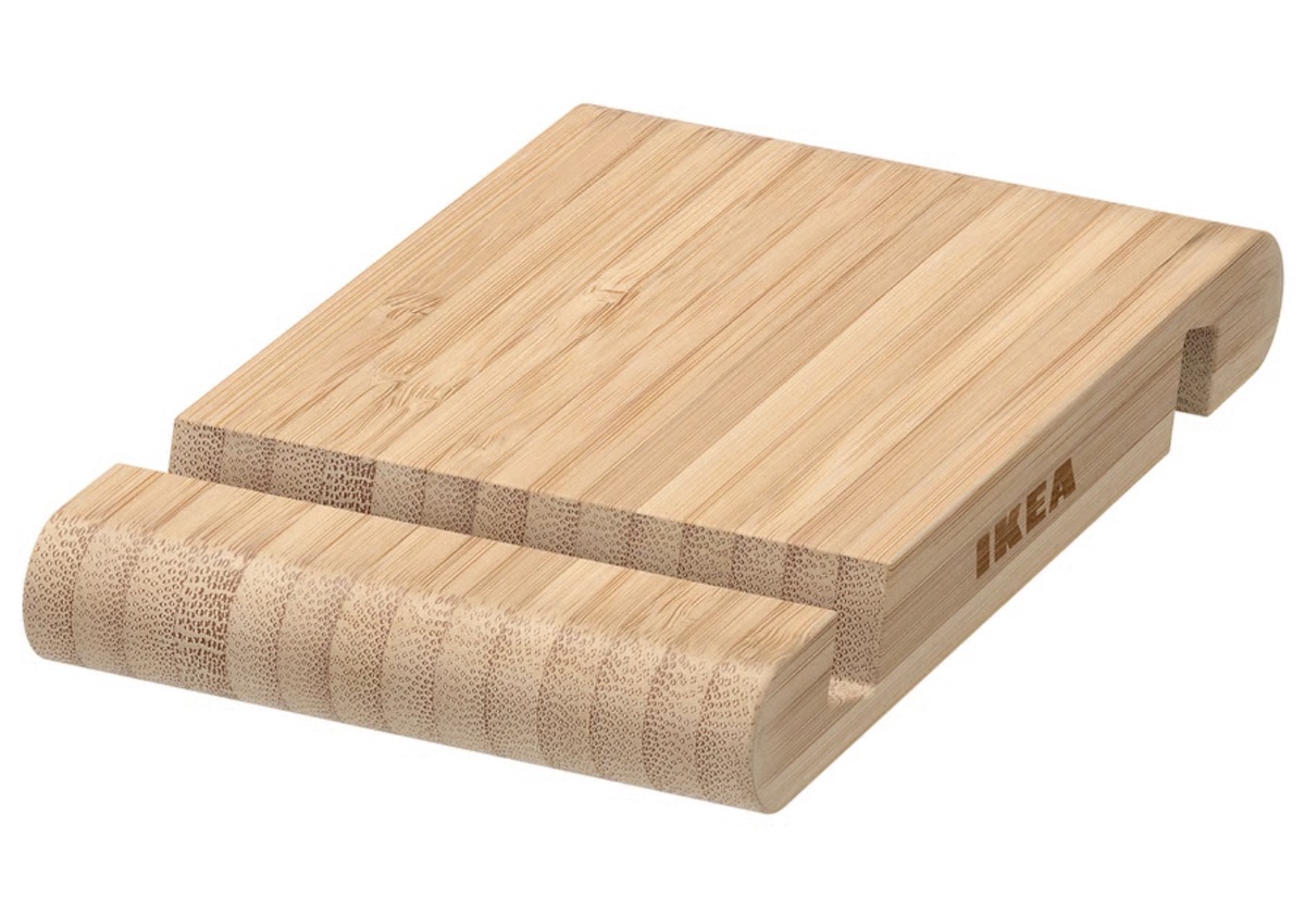 A rectangular bamboo phone or tablet stand with a groove for holding devices, featuring the IKEA logo on the side.