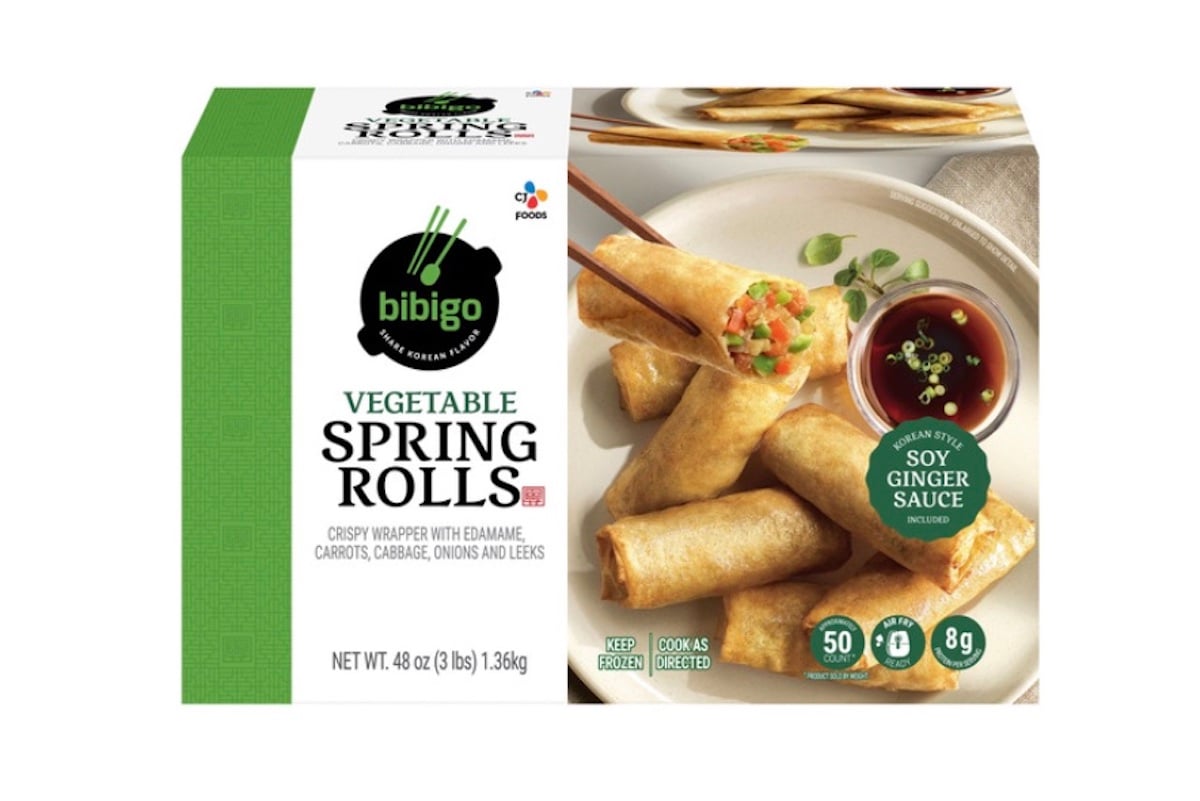 Box of Bibigo Vegetable Spring Rolls featuring an image of spring rolls on a plate with soy ginger sauce. The box highlights ingredients and nutrition, with green and white packaging.