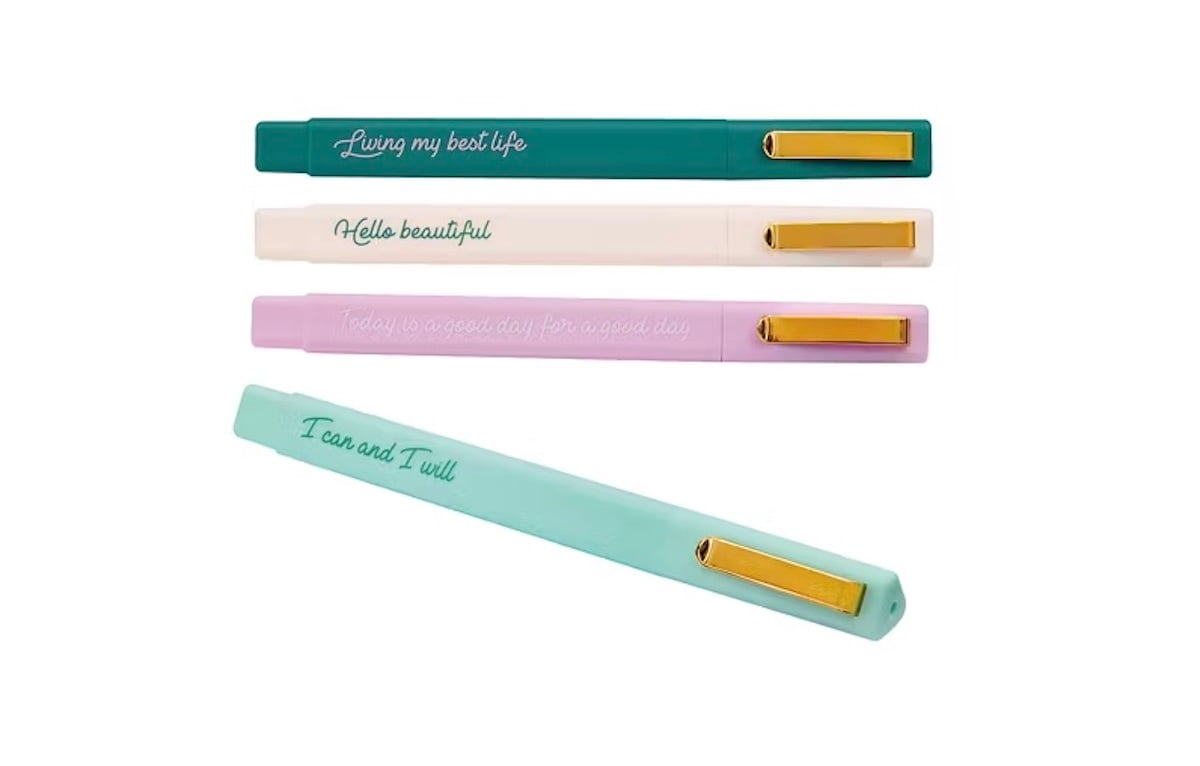 Four colorful pens with gold clips, each featuring a motivational phrase: "Living my best life," "Hello beautiful," "Today is a good day," and "I can and I will," arranged on a white background.