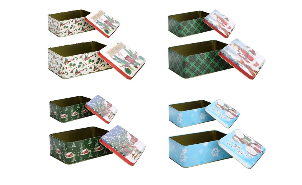 Four pairs of rectangular holiday-themed tins with removable lids, each featuring festive patterns like holly, plaid, snowflakes, Santa, and Christmas trees. The tins are shown open with lids beside them.