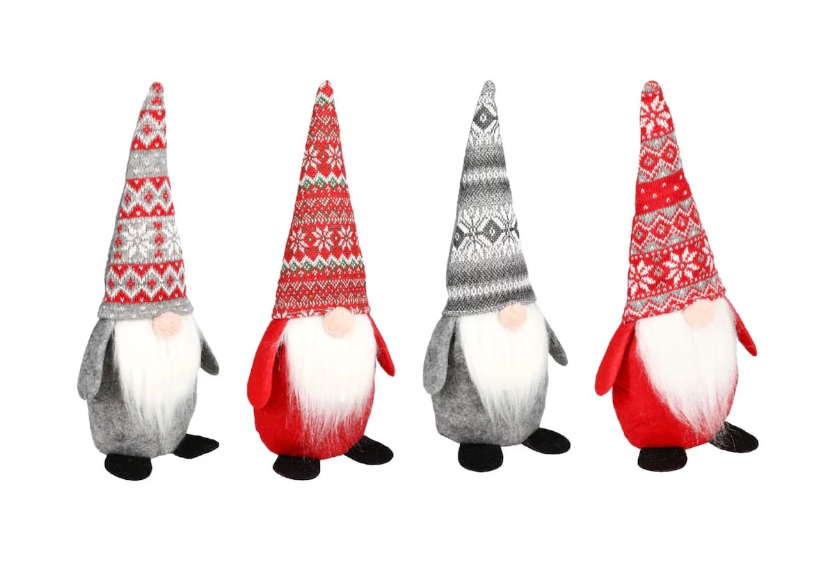 Four plush gnome dolls with long white beards and tall patterned hats, featuring red, grey, and white designs, standing in a row on a white background.