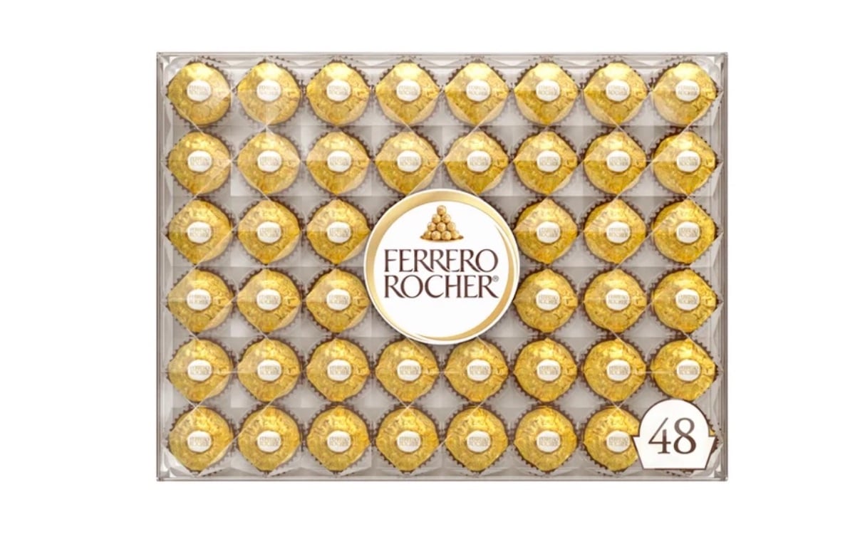 A box of 48 Ferrero Rocher chocolates is arranged in a grid, each chocolate wrapped in gold foil with a label on top, and a large round Ferrero Rocher logo in the center of the box.