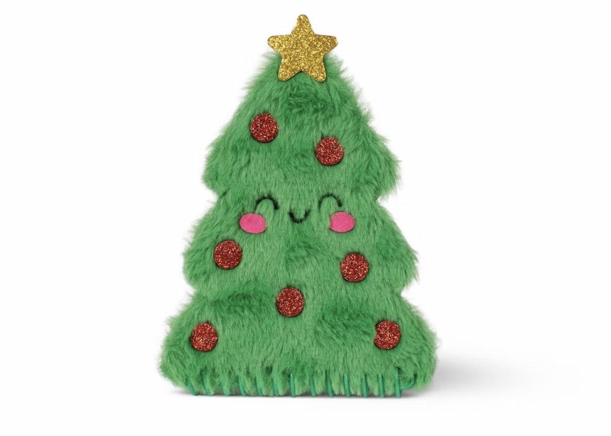 A plush green Christmas tree toy with a smiling face, pink cheeks, red glittery ornaments, and a gold glitter star on top.
