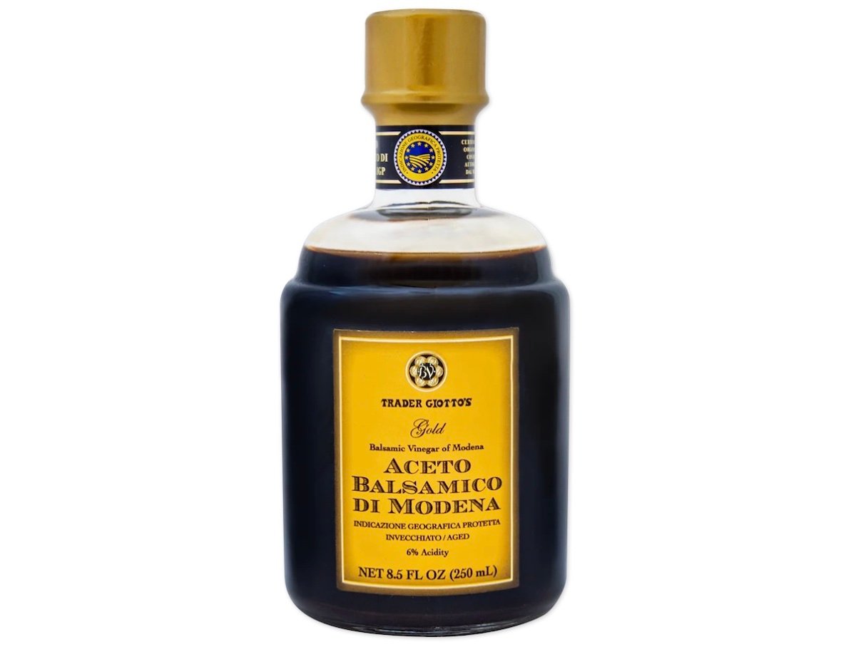 A bottle of Trader Giotto’s Gold Aceto Balsamico di Modena balsamic vinegar with a gold and yellow label, containing 8.5 fluid ounces (250 mL).