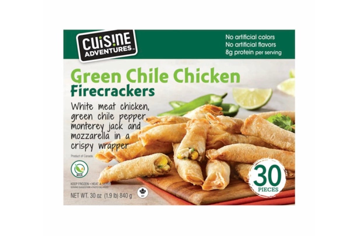 Box of Cuisine Adventures Green Chile Chicken Firecrackers showing crispy wrapped snacks on a plate with lime wedges. Text highlights 30 pieces, white meat chicken, green chile pepper, and cheese in a crispy wrapper.