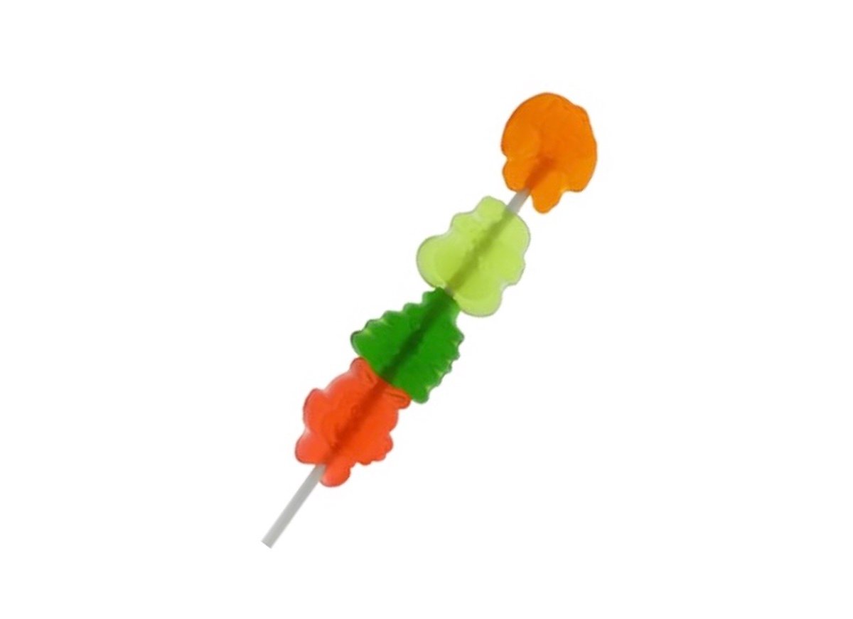 A skewer with gummy candies shaped like animals and trees in orange, green, and red colors, arranged on a white background.