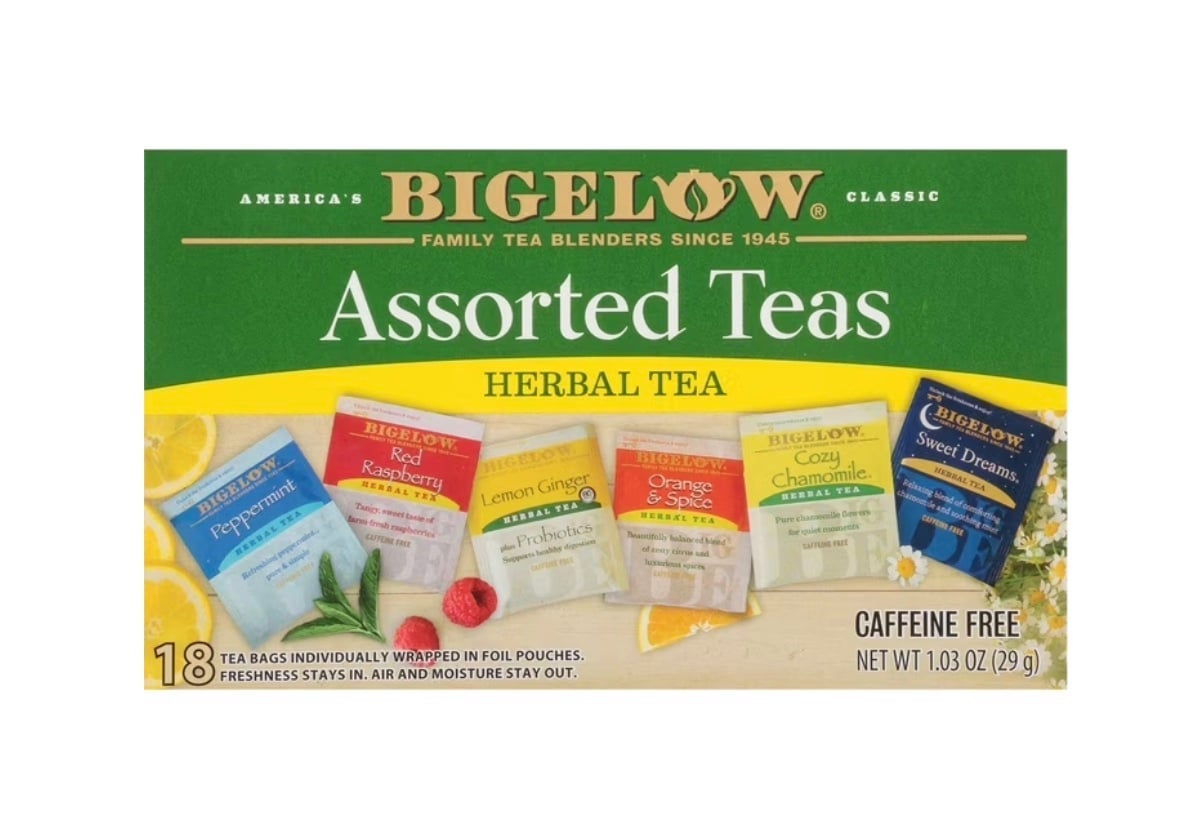 A box of Bigelow Assorted Teas featuring six herbal tea varieties: Peppermint, Red Raspberry, Lemon Ginger, Orange & Spice, Cozy Chamomile, and Sweet Dreams. The box contains 18 caffeine-free tea bags.