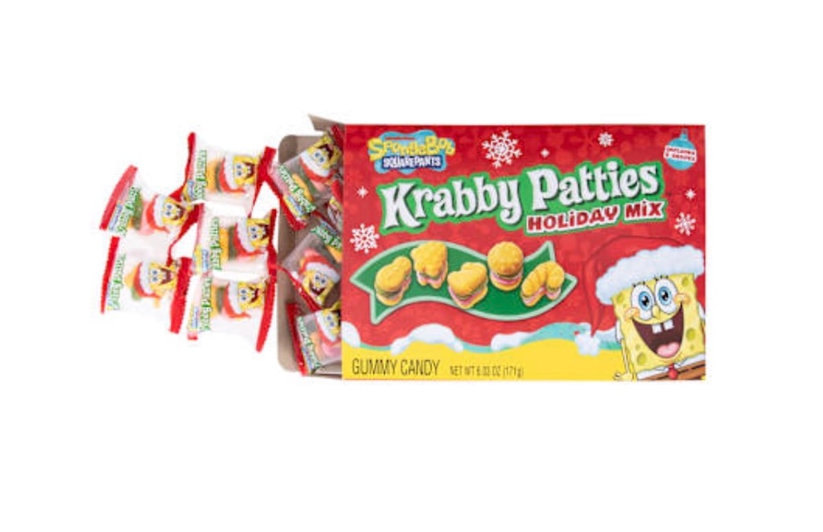 A red box labeled "Krabby Patties Holiday Mix" features SpongeBob SquarePants in a Santa hat. Several individually wrapped gummy candies are spilling out of the box.