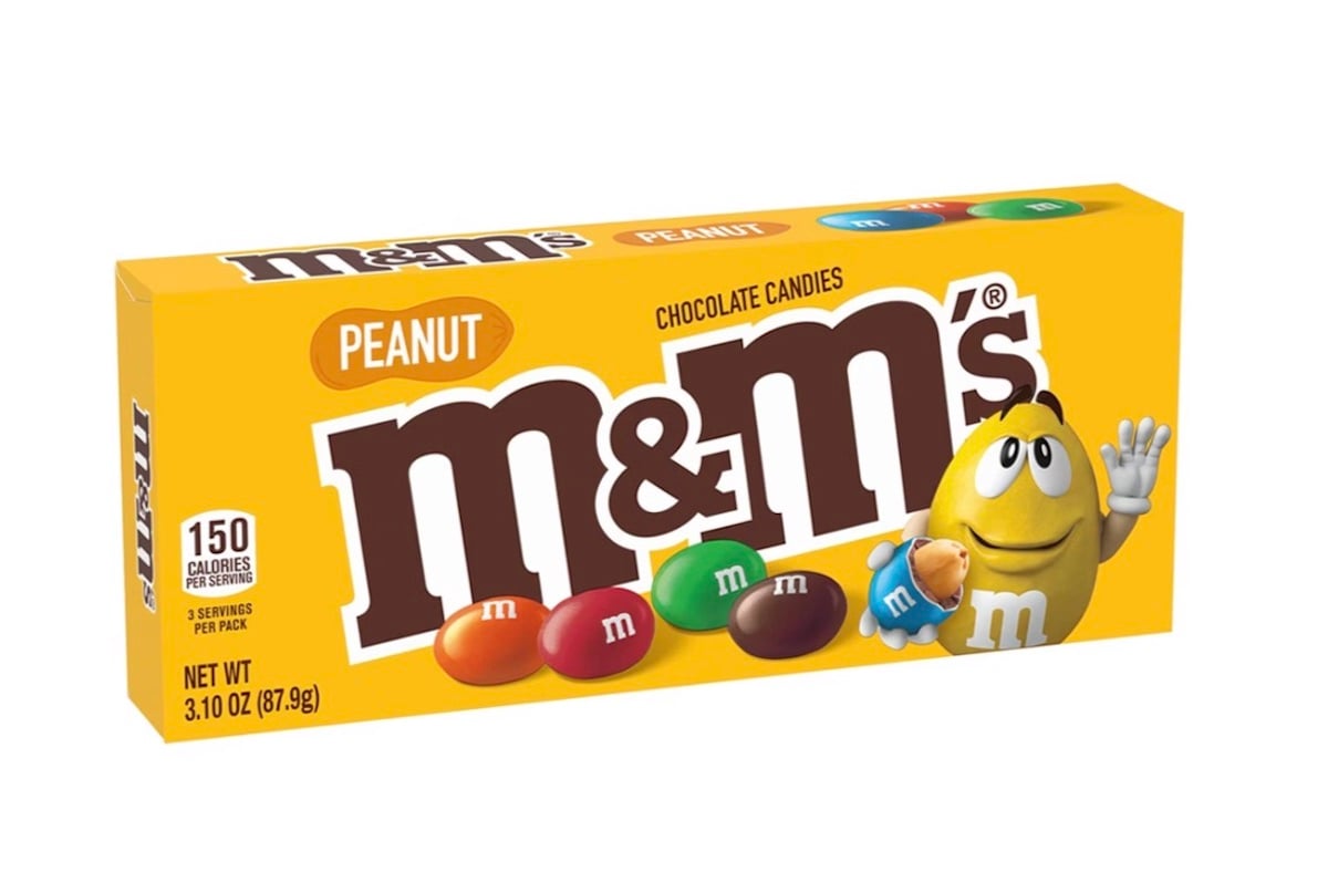 Yellow box of peanut M&M’s chocolate candies with colorful candies on the front and the yellow M&M mascot waving, next to a peanut. The packaging shows nutrition info and net weight of 3.10 oz (87.9g).