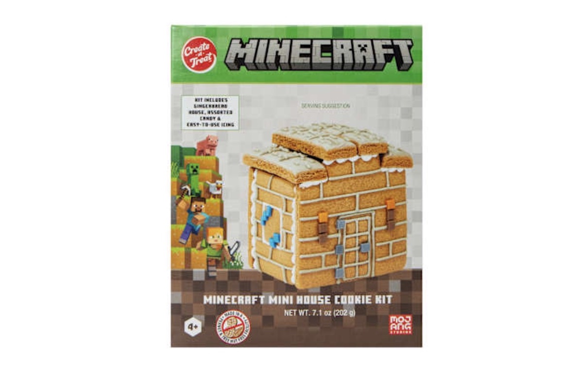 A Minecraft-themed mini house cookie kit box featuring a cookie house designed to look like a Minecraft building, with game characters on the left and detailed kit contents listed on the front.