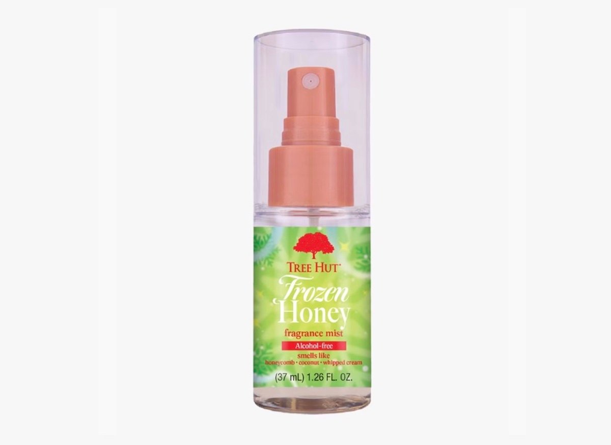 A clear plastic bottle of Tree Hut Frozen Honey fragrance mist with a pink spray nozzle and green and yellow label, containing 1.26 fl oz (37 ml) of product.