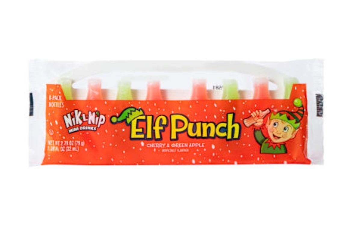 A package of Nik-L-Nip Elf Punch mini drinks with six wax bottles in red and green, labeled "Elf Punch" with an illustrated elf on a red, snow-speckled background. Flavors are cherry and green apple.