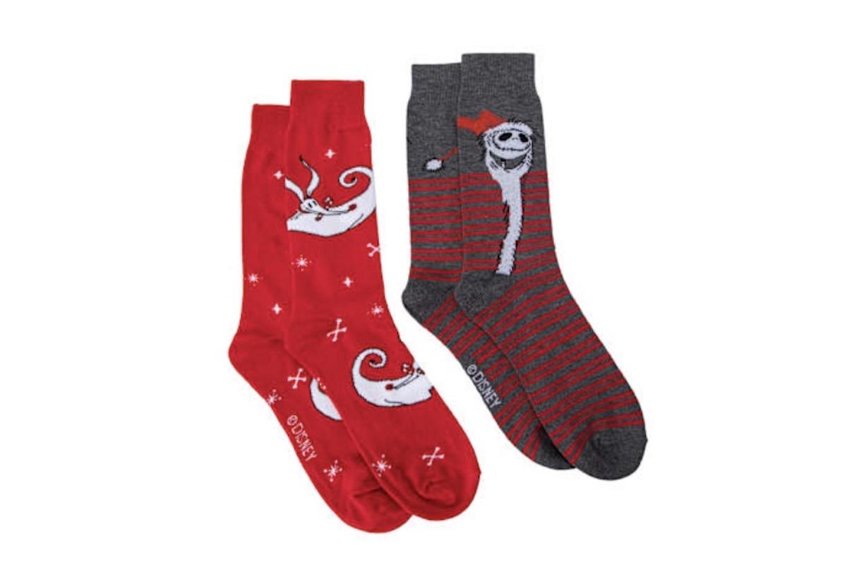 Two pairs of socks: one red with an image of Zero the ghost dog and snowflakes, and one gray with red stripes featuring Jack Skellington from "The Nightmare Before Christmas.
