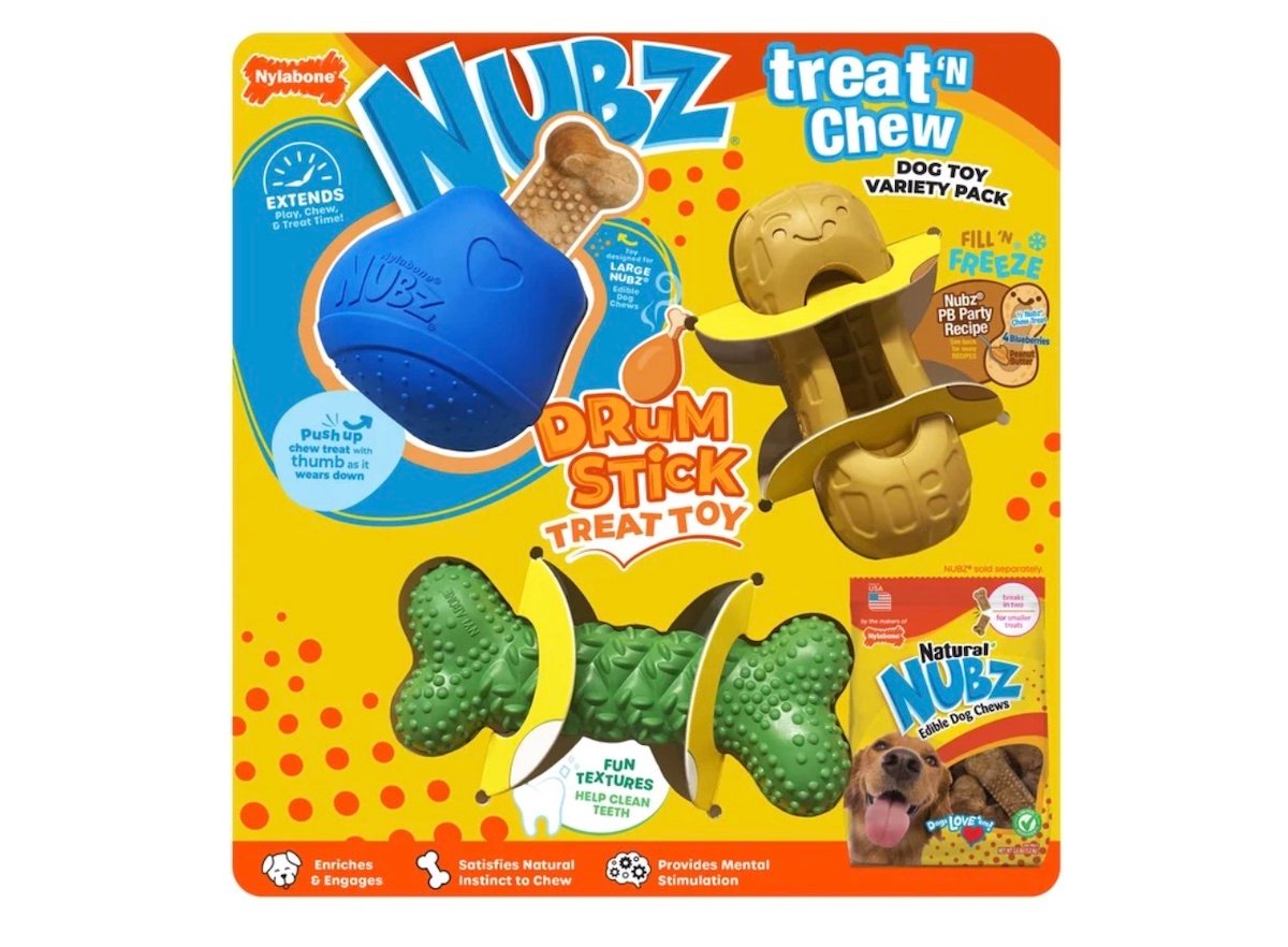 Colorful packaging for Nylabone Nubz Drum Stick Treat Toy, showing a blue and green textured dog chew toy, treat compartments, product features, and a small image of a dog chewing the toy.