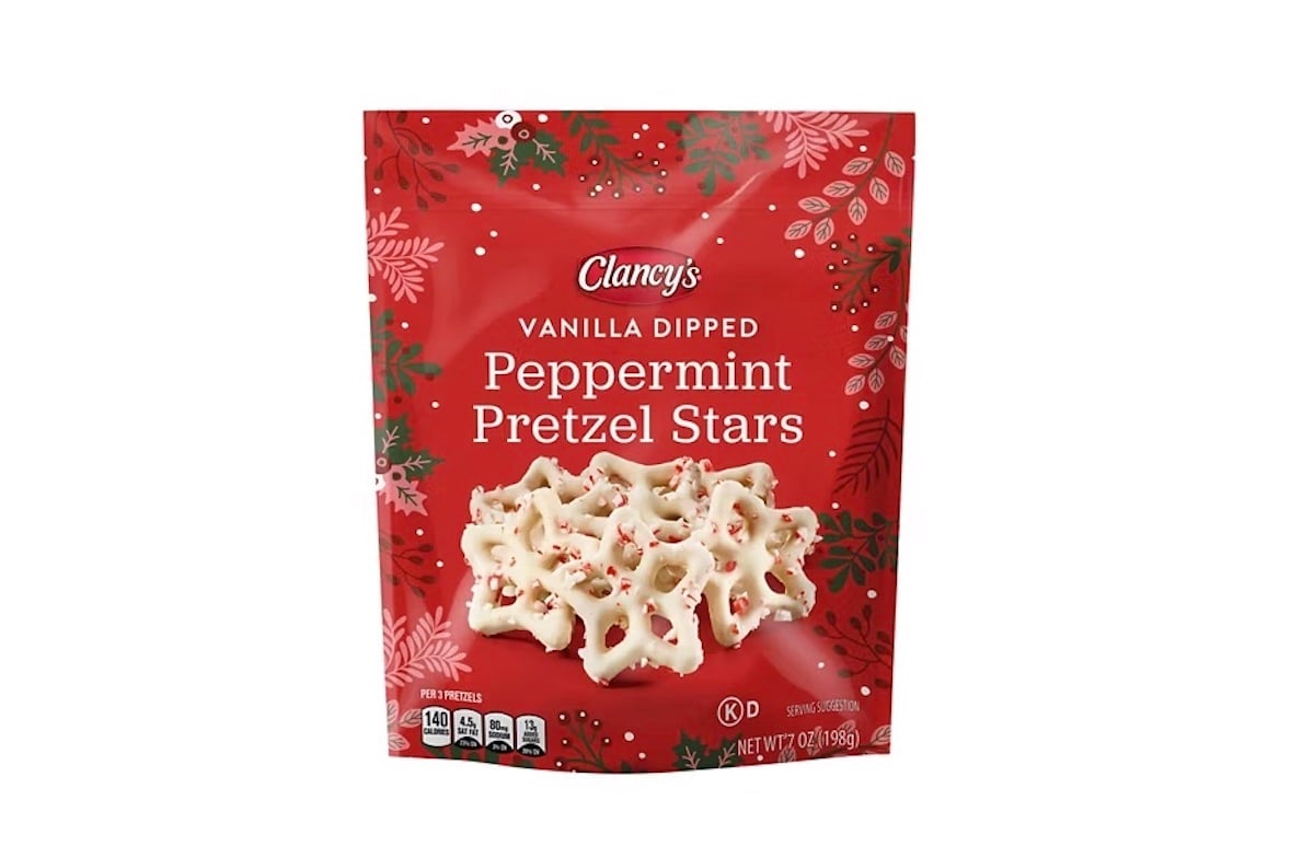 A red festive bag labeled "Clancy's Vanilla Dipped Peppermint Pretzel Stars" features a photo of white chocolate-covered star-shaped pretzels with peppermint pieces, surrounded by holiday-themed decorations.