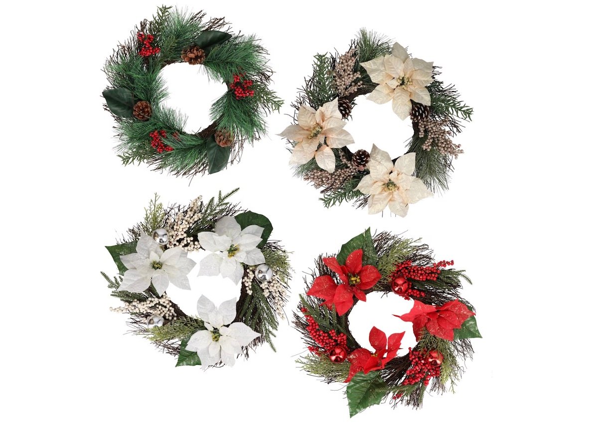 Four festive holiday wreaths with pine needles, berries, pine cones, and artificial flowers in red and white, displayed on a white background.