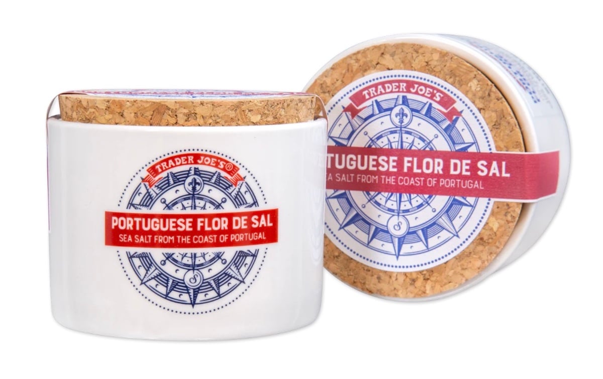 A ceramic jar with a cork lid labeled "Trader Joe's Portuguese Flor de Sal, sea salt from the coast of Portugal," featuring a blue nautical compass design on the front.