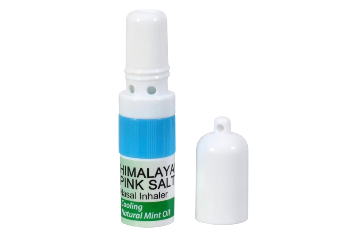 A white and blue nasal inhaler labeled "Himalaya Pink Salt Nasal Inhaler" with natural mint oil, shown with its white cap removed and placed beside it on a white background.