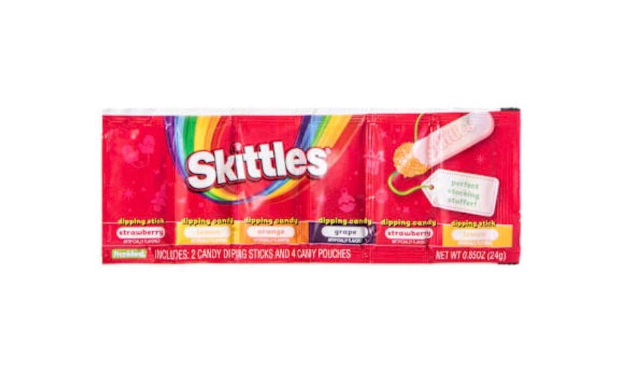 A package of Skittles Dips featuring rainbow graphics, labeled with dipping candy flavors: strawberry, orange, and grape. The package includes two candy dipping sticks and four candy pouches.