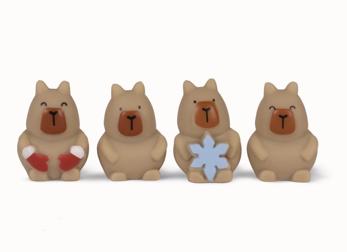 Four small, brown bear figurines are lined up. Two are smiling, one holds red mittens, one holds a blue snowflake, and one has a neutral face. All have darker snouts and simple features.