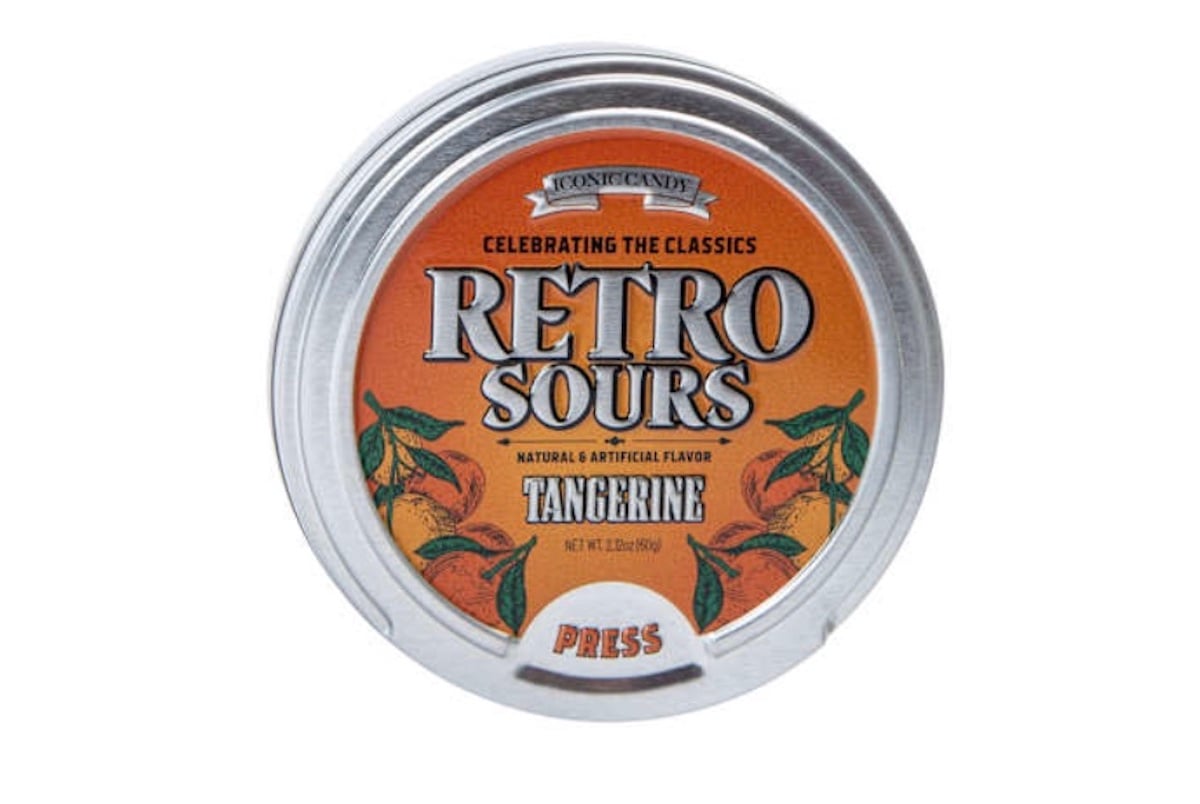 A round metal tin labeled "Retro Sours" tangerine flavor, with an orange background, vintage-style text, and illustrations of tangerines around the edges.